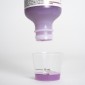 Purple liquid medicine being poured into dosing cup