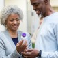 Seniors reading medicine bottle labels in pharmacy