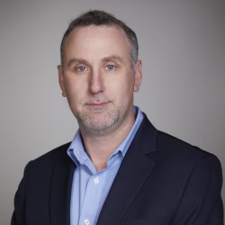 Josh Long Headshot in black suit and blue shirt